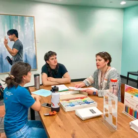 People and markers on the Art Table